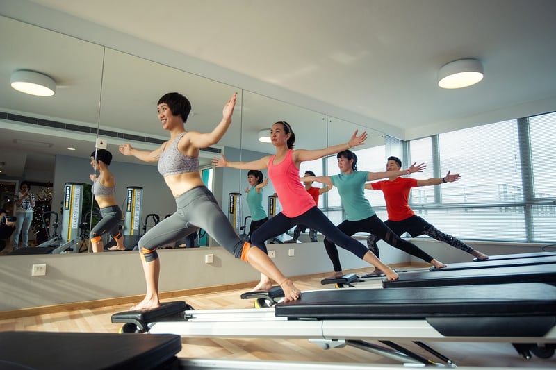 Woman practicing Pilates on a reformer